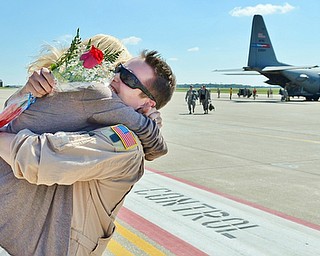 Jeff Lange | The Vindicator  Captain Jacob Papp hugs his girlfriend Adina Szewczyk after being away in Southwest Asia for 120 days, Friday afternoon at the Youngstown Air Reserve Base in Vienna.