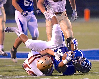 Jeff Lange | The Vindicator  Poland running back Marlon Ramirez is flipped by Eagles' defensive back Luke Nutter during the first half of their Friday night matchup at Dave Pavlansky Field.
