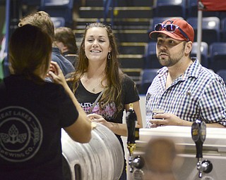 Katie Rickman | The Vindicator.Josselyn and Pat Anderson, both of Youngstown, enjoy beer while talking with Caroline Macdonell, a Brand Ambassador of Great Lakes Brewing Co. at the second Beer Fest at the Covelli Centre on Saturday, Sept. 20, 2014.