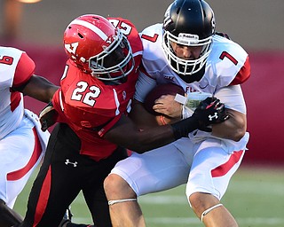 YOUNGSTOWN, OHIO - SEPTEMBER 20, 2014: Quarterback Zack Drayer #7 of Saint Francis is tackled by linebacker Dubem Nwadiogbu #22 of YSU during the 1st half of Saturday nights game NCAA football at Stambaugh Stadium. (Photo by David Dermer/Youngstown Vindicator)
