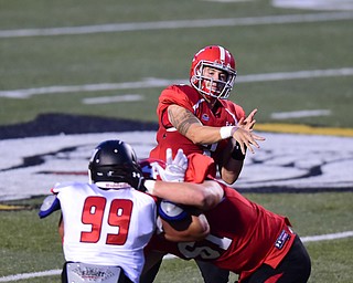 YOUNGSTOWN, OHIO - SEPTEMBER 20, 2014: Quarterback Dante Nania #3 of YSU throws a pass during the 1st half of Saturday nights game NCAA football at Stambaugh Stadium. (Photo by David Dermer/Youngstown Vindicator)