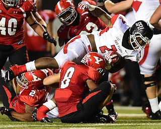 YOUNGSTOWN, OHIO - SEPTEMBER 20, 2014: Running back Lorenzo Jerome #2 of Saint Francis is brought down by Donald D'Aalesio #8 of YSU during the 1st half of Saturday nights game NCAA football at Stambaugh Stadium. (Photo by David Dermer/Youngstown Vindicator)
