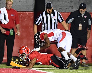 YOUNGSTOWN, OHIO - SEPTEMBER 20, 2014: Running back Jody Webb #20 of YSU dives into the end zone to score a touchdown while being hit by defensive back DaQuan Minter #14 of Saint Francis during the 1st half of Saturday nights game NCAA football at Stambaugh Stadium. (Photo by David Dermer/Youngstown Vindicator)