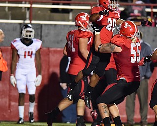 YOUNGSTOWN, OHIO - SEPTEMBER 20, 2014: Running back Jody Webb #20 of YSU is picked up by teammate Trevor Strickland #55 after scoring a touchdown during the 1st half of Saturday nights game NCAA football at Stambaugh Stadium. (Photo by David Dermer/Youngstown Vindicator) Saint Francis defensive back DaQuan Minter #14 pictured.