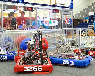 Jeff Lange | The Vindicator  Austintown Fitch boys (red shirts) Westly Pringle (left) and Hunter Hykes (right) concentrate on driving their robot, Saturday afternoon at Fitch High School.