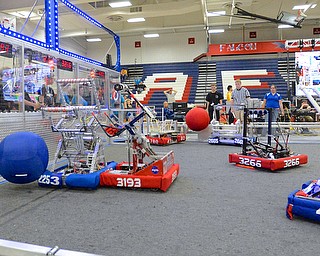 Jeff Lange | The Vindicator  Austintown's (red shirts) focus on navigating their robot in the aerial assist challenge in which the teams are to make their robots pick up and throw balls through various goals in the court.