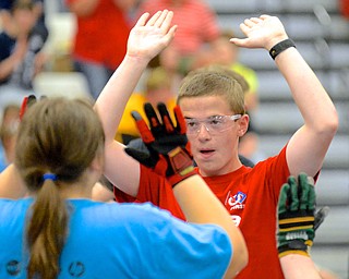 Jeff Lange | The Vindicator  Austintown junior Garrett McGinty (right) celebrates a victory with teammate Alexis Weekley, a sophomore from Parma, Saturday during the Mahoning Valley Robotics Challenge at Austintown HS.
