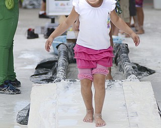 Katie Rickman | The Vindicator.Lexa Hoffman, 5, of Salem runs through  a water and corn starch paste at Silly Science Sunday at Oh Wow downtown Youngstown Sunday, Sept. 21, 2014.