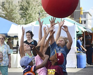 Katie Rickman | The Vindicator.A group of kids throw their hands in the air as they try to catch a ball that a robot from the  Austintown High School robotics team at Silly Science Sunday downtown Youngstown on Sunday, Sept. 21, 2014.