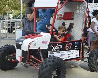 Katie Rickman | The Vindicator.Vaughn Hinrichs, 5, of Boardman pretends to race in a small race car at Silly Science Sunday at Oh Wow in Sunday, Sept. 21, 2014 in Youngstown, Ohio.