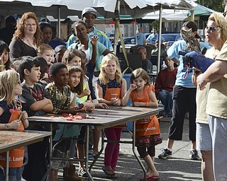 Katie Rickman | The Vindicator.Anthony Merrit, on right, of Birds in Flight Animal Sanctuary in Warren holds a screech owl as children look on during Silly Science Sunday downtown Youngstown on Sunday, Sept. 21, 2014.