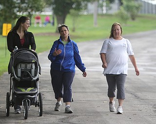 Rebekah Ostrode (left) of Poland pushes her son Dominic in a stroller while walking with Pam Woychik of Cortland (middle) and Sue Ostrode (right) of Cortland during the Super Walk for Multiple Sclerosis at the Wick Recreation Area of Mill Creek Park on Sunday morning.  Dustin Livesay  |  The Vindicator  09/21/14  Mill Creek Park.