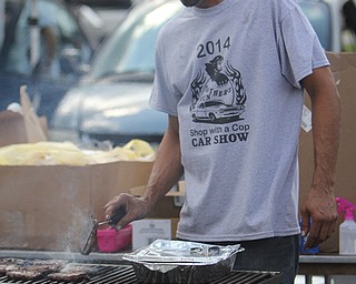Nick Rodriguez of Struthers cooks hamburgers during the Cops Car Show in the Struthers Plaza in Struthers on Sunday afternoon.  Dustin Livesay  |  The Vindicator  09/21/14  Struthers Plaza.