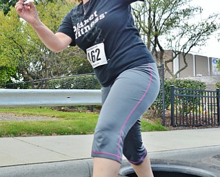 Jeff Lange | The Vindicator  Josie Hale of Boardman winces as she hops through the semi tire challenge, Sunday morning in the streets of Youngstown during the 1st annual Steelathon 5K race.