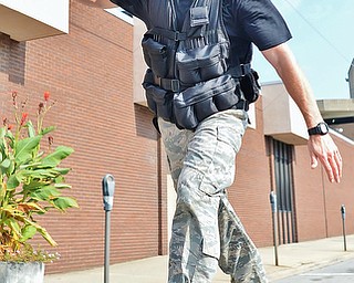 Jeff Lange | The Vindicator  Vindicator sports writer Ryan Buck balances as he makes his way across the balance beam on the home stretch of the Steelathon 5K race held in the streets of downtown Youngstown, Sunday, September 21st.