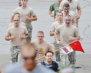 Jeff Lange | The Vindicator  Members of the YSU Army ROTC unit begin their assault on the uphill portion of the Steelathon, Sunday morning in Youngstown.