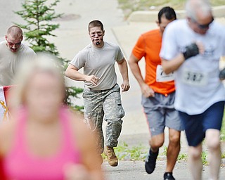 Jeff Lange | The Vindicator  Adam Hoover (center), member of YSU's Army ROTC program calls cadences as he hustles along the course of the 1st annual Steelathon 5K race, Sunday, September 21st.