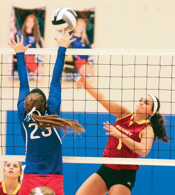 Western Reserve’s Marissa Phillps (23) tries to block a shot by Cardinal Mooney’s Jaclyn Yankle during Monday’s match at Western Reserve High School in Berlin Center.