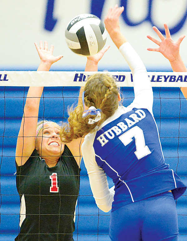 Canfield’s Janie Rafoth (1) attempts to block a spike made by Hubbard’s Macey Sarisky during Tuesday’s match in
Hubbard.