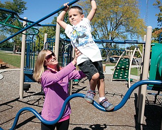 Stephanie Yon of Lowellville plays with her 4-year-old son, Steven, at the Wick Recreation Area in Mill Creek Park. Earlier this week, the recreation area was the site of the first installment of the Healthy Kids Running Series, which will continue Sunday. Yon is responsible for bringing the series to Youngstown.
