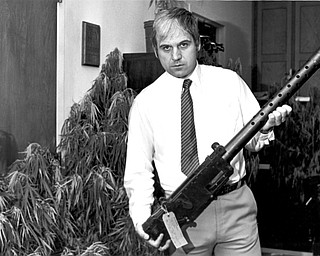 September 13, 1982 - Traficant holds a .30-caliber air cooled machine gun which was seized on September 9, 1982.