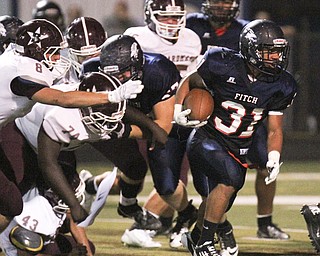Wlliam D Leiws the Vindicator  Fitch's Tyler Hewitt(31) scampers of yardage against Boardman 9-26-14.