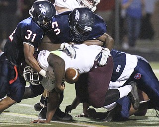 William D Lewis The Vindicator   Boardman's Benji roberts(21) fumbles after being hit by Fitch's Tyler Hewlett(31) and Jalen Fletcher(50) during first half action Friday at Fitch.