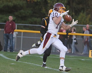 South Range's Greg Dunham (10) bobbles a catch that he would run for a touchdown while being defended by Crestview's Jared Hayden (2) during the first quarter of Friday nights matchup at Crestview High School in Columbiana.   Dustin Livesay  |  The Vindicator  09/26/14  Crestview High School.