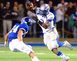 Jeff Lange | The Vindicator  Hubbard running back Larry Scott (3) runs into the defense of Poland's Austin Wilson in the first half of their Friday night matchup at Dave Pavlansky Field.
