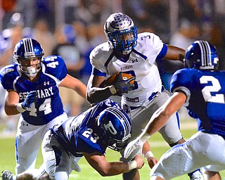 Jeff Lange | The Vindicator  Hubbard running back Larry Scott breaks through the line as Poland's Adam Wollet brings him down late in the first half, Friday night in Poland.