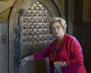 .Angela Small gives a tour of the Arms Family Museum at 648 Wick Ave, explaining the "Arts and Crafts movement was favored by Olive A. Arms who  personally designed the home. Small says that the doorway shows the style in the shape of the door, the glass, and the lizard shape handle.  The Mahoning Valley Historical Society honored military personnel by offering free tours of the museum on Saturday, Sept. 27, 2014.