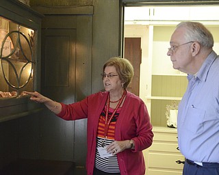 .Angela Small gives a tour of the Arms Family Museum at 648 Wick Ave, showing silver spoons to Ken Dean of Struthers who is a U.S. Navy Veteran on Saturday, Sept. 27, 2014.  The Mahoning Valley Historical Society honored military personnel by offering free tours of the museum.