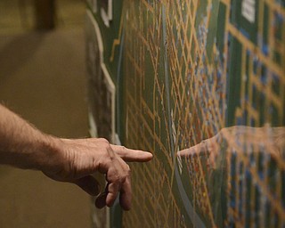 .A man points to roads on a map of Youngstown that is on display at the Arms Family Museum, the map shows the way the city once was, including dots that explained where different ethnicities once lived.  The Mahoning Valley Historical Society honored military personnel by offering free tours of the museum on Saturday, Sept. 27, 2014.