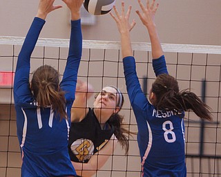Western Reserve's Sydney Miller (8) and Kalina Wisniewski (17) jump to try and block a spike by Crestview's Abbie Gallagher (18) during Saturday morning's matchup at Western Reserve High School in Berlin Center. 