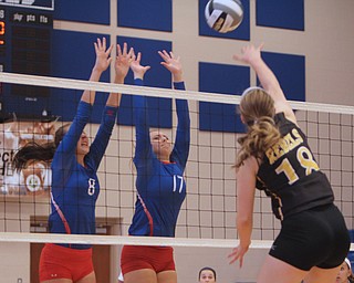 Western Reserve's Sydney Miller (8) and Kalina Wisniewski (17) jump to try and block a spike by Crestview's Abbie Gallagher (18) during Saturday morning's matchup at Western Reserve High School in Berlin Center.