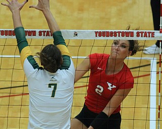 Youngstown State's Lexi Egler (2) spikes the ball past the block set up by Wright State's Ashley Langjahr (7) during Saturday afternoons matchup at the Beeghly Center.