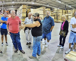 Shawn Fieldhouse of New Waterford (pointing) gives festival goers a tour of the warehouse during Saturday's 3rd Annual Red, White and True Festival held at Baird Brothers Fine Hardwoods.