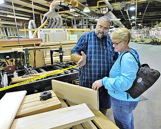Greg Shook of Ellsworth examines cut wood with his wife Peg during a tour of Baird Brothers Fine Hardwood in Canfield during the 3rd annual Red, White and True Festival, Saturday.