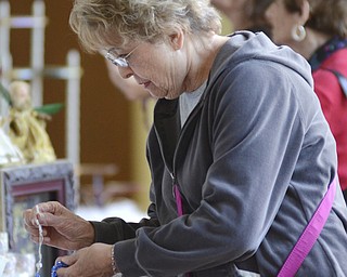 Louise Creatura of Austintown picks up a rosary for a family member at the Ukrainian Festival at St. Anne Ukrainian Church on Sunday, September 28, 2014 in Austintown.