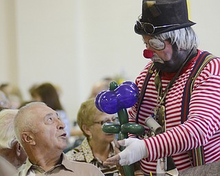"Pops" The Clown makes a balloon for Rudy Verhas of New Lyme, Ohio at the Ukrainian Festival at St. Anne Ukrainian Church on Sunday, September 28, 2014 in Austintown.