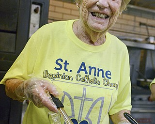 Liz George of Poland serves up hot stuffed cabbage that was going quick at the Ukrainian Festival at St. Anne Ukrainian Church on Sunday, September 28, 2014 in Austintown.