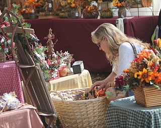 Dale Russ of North Lima looks through a basket of crafts during the Oktoberfest at the Boardman Park on Sunday afternoon.