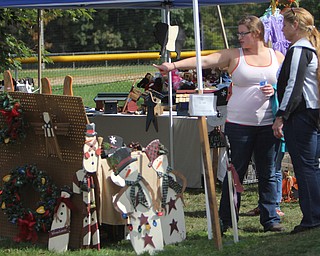 Charlene Frazier (right) of Poland looks at crafts with her daughter Stephanie Frazier also of Poland during the Oktoberfest at the Boardman Park on Sunday afternoon.