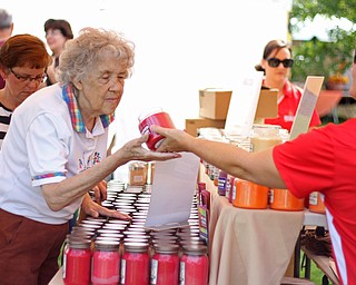 Susan Hertel of the Beaver Creek Candle Company (right) holds out a candle for Bettie Sue Christman (left) of Brookfield to smell during the Oktoberfest at the Boardman Park on Sunday afternoon.  Dustin Livesay  |  The Vindicator  09/28/14  Boardman Park.