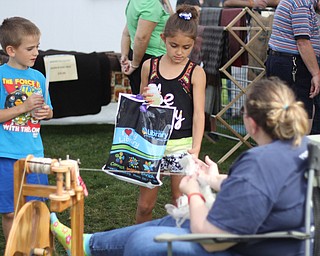 Siblings Brice Bailing (7,left) and Brooklyn Hink (7) both of Poland watch as yarn is made for hats by Connie Prtz of Crooked Creek Alpacas during the Oktoberfest at the Boardman Park on Sunday afternoon.  Dustin Livesay  |  The Vindicator  09/28/14  Boardman Park.