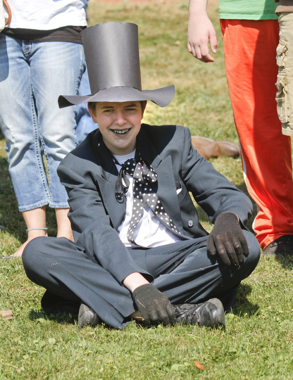        ROBERT K. YOSAY  | THE VINDICATOR..Derek Godfrey watches from shore as he team mates  "take the ""BAT BOAT"" across the lake"..The Annual Raider  Regatta done annually by 10th grade students at Memorial Park behind the old high School ...-30-