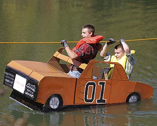        ROBERT K. YOSAY  | THE VINDICATOR.."DUKES OF HAZARD pulls a wheelie as Colin Razo and Dante Pecchia (yellow vest take off..The Annual Raider  Regatta done annually by 10th grade students at Memorial Park behind the old high School ...-30-