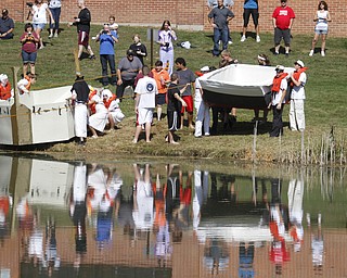        ROBERT K. YOSAY  | THE VINDICATOR..Fun Reflection as Giza Goonies and the Titanic Part 2 enter the water....The Annual Raider  Regatta done annually by 10th grade students at Memorial Park behind the old high School ...-30-