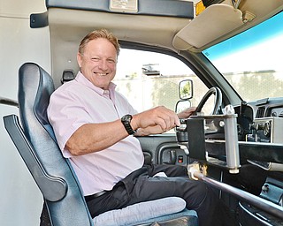 Jeff Lange | The Vindicator  Struthers Mayor Terry Stocker sits in the drivers seat of the new senior van purchased from Lowellville. The van is set to take the streets Tuesday, September 29th.