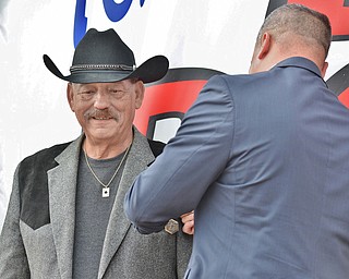 Jeff Lange | The Vindicator  Executive Director of the Trumbull County Veterans Service Commission, Herman Bruer places the Army Commendation Medal on Thomas Ducharme's chest during the awards ceremony held at Texas Big Dog in Warren, Monday morning.